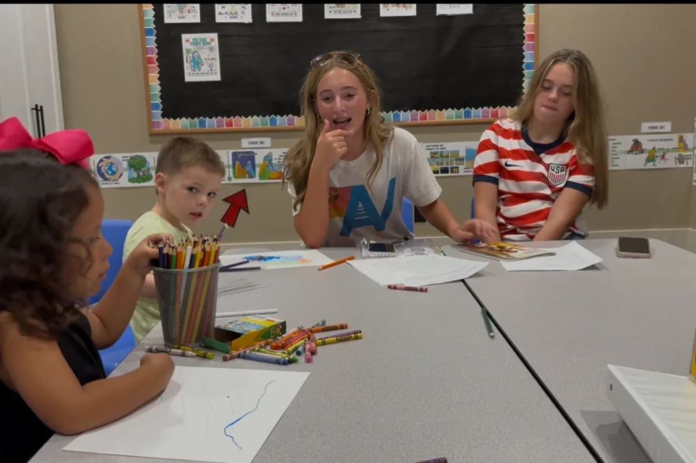 Younger children working at a table in a Bible class